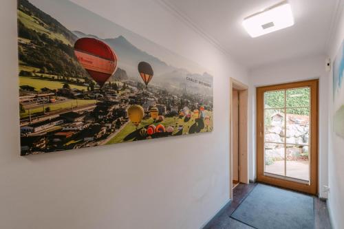 a painting of hot air balloons on a wall at Chalet Weinberg Top 1 & Top 2 by Apartment Managers in Kirchberg in Tirol