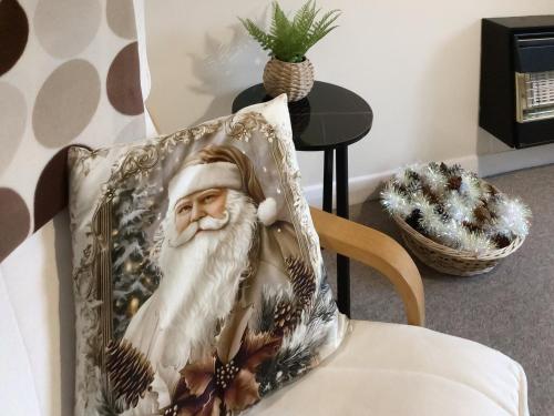 a picture of santa claus on a pillow on a chair at Rosings in Bradfield