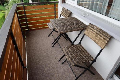 two chairs and a table on a balcony at Giessen Hotel & Coffeehouse in Vaduz