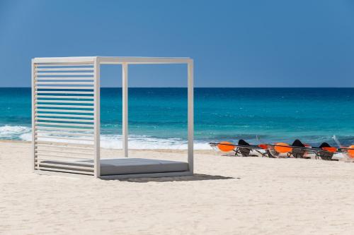 a cage on the beach with a group of surfboards at My Ōtel North Coast - Adult Only in Al Dabaa