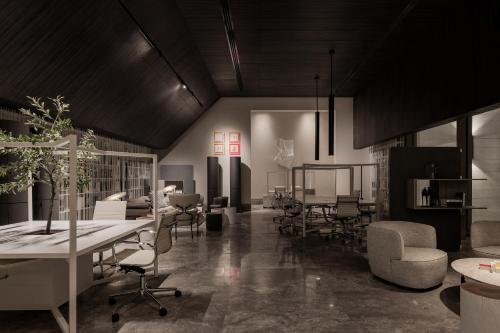 an office with chairs and tables and a room with tables and chairs at My Ōtel North Coast - Adult Only in Al Dabaa
