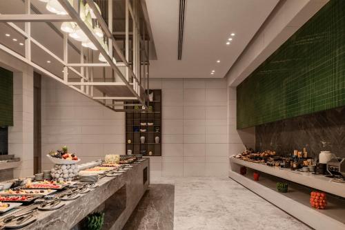 a buffet line with many different types of food at My Ōtel North Coast - Adult Only in Al Dabaa