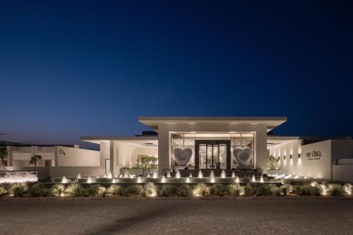 a large white building with lights in front of it at My Ōtel North Coast - Adult Only in Al Dabaa