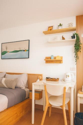a bedroom with a bed and a table and a desk at Homeku Guesthouse Room 3 Cozy Stay Close to Suvarnabhumi Airport in Lat Krabang