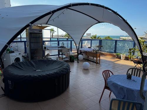 a room with a large tire in a tent at Swita Nir - Hot tub, Beach & Barbeque in Ashdod