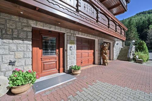 a building with a door and two potted plants at Hotel Resort Martin & Kristyna in Špindlerův Mlýn