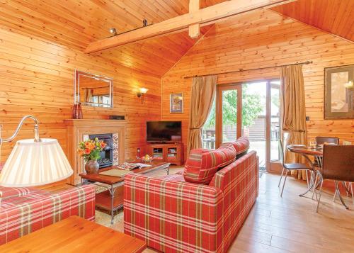 a living room with two couches and a fireplace at Tilford Woods Lodge Retreat in Farnham