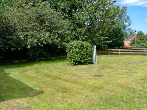 a yard with a sign in the grass at Stronvaar in Stranraer