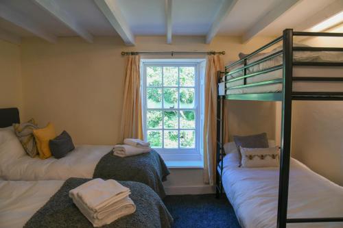 a bedroom with two bunk beds and a window at Temple Croft Bed and Breakfast in Alston