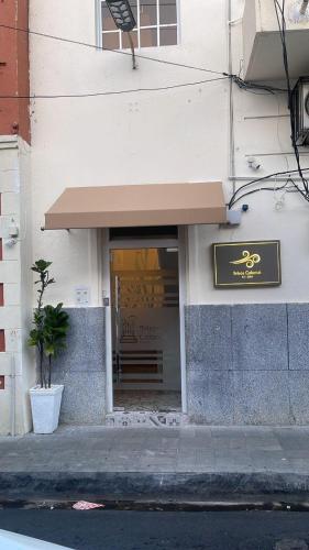 a building with a sign on the front of it at Hotel Boutique Brisas Colonial in Santo Domingo