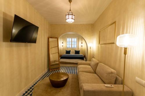 a living room with a couch and a bed at NJ House in Tangier