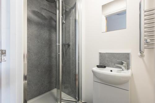 a bathroom with a sink and a shower at St James Court Hotel in Derby