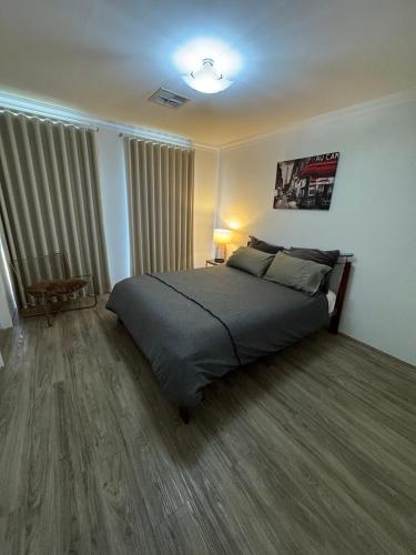 a bedroom with a large bed in a room at The Lux Dip in Perth