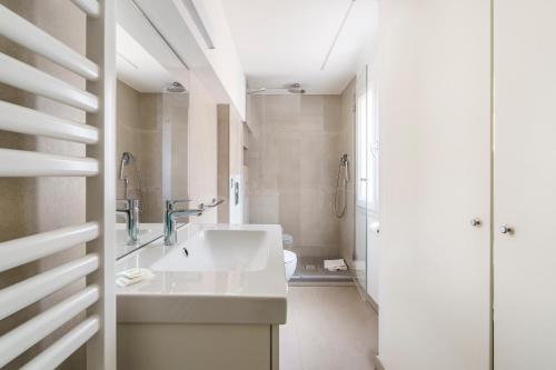 a white bathroom with a sink and a toilet at CDT Duomo in Florence