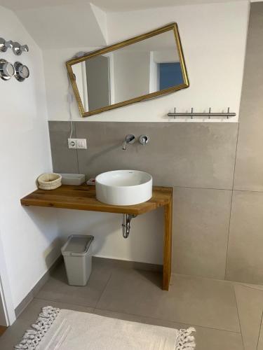 a bathroom with a sink and a mirror at Rufus' Bergblick in Bernau am Chiemsee