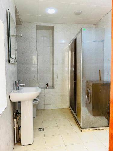a bathroom with a sink and a shower and a toilet at Nizami Hostel in Baku