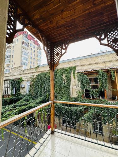 a balcony with green plants on a building at Nizami Hostel in Baku