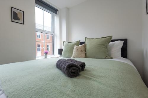 a bedroom with a large bed with a large window at St James Court Hotel in Derby