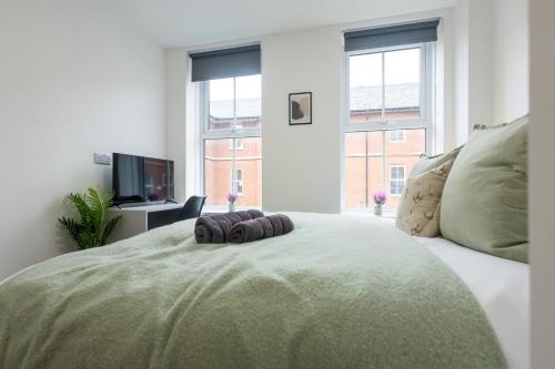 a bedroom with a large bed with a television at St James Court Hotel in Derby