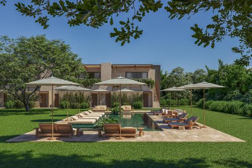 a patio with tables and chairs and umbrellas at Casa Simona in Valle de Anton