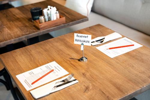 a wooden table with a sign on top of it at Giessen Hotel & Coffeehouse in Vaduz
