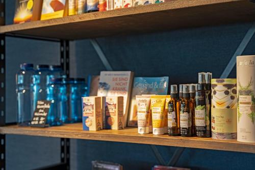 a shelf with bottles of hair products on it at Giessen Hotel & Coffeehouse in Vaduz