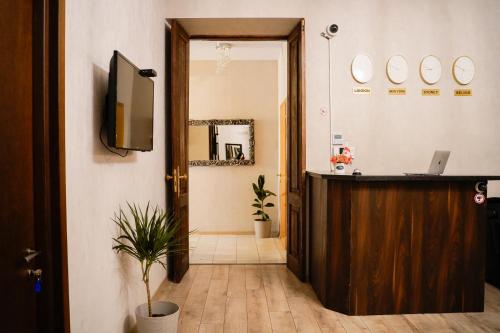 a hallway with a door and a television in a room at Hotel Griboedov in Tbilisi City