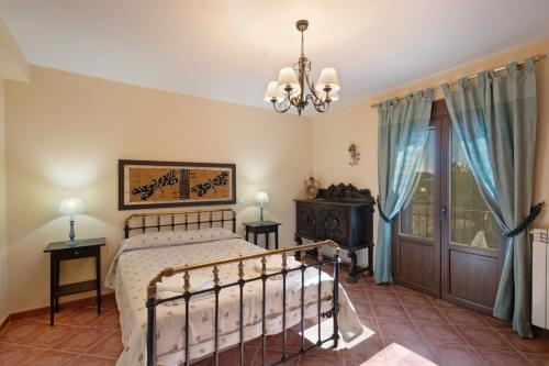 a bedroom with a bed and a window at Los Diegos in Navarrete del Río