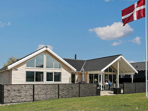 a house with a flag in front of it at Luxury Pool Retreat by Sea - By Traum Ferienwohnungen in Bogense