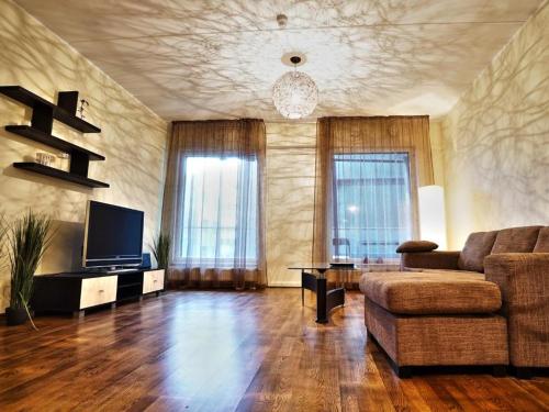 a living room with a couch and a television at Easty Stay Apartments - City Centre in Tallinn