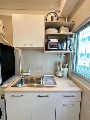 an rv kitchen with a sink and a window at Cozy & Affordable apartment in Chiang Mai in Chiang Mai