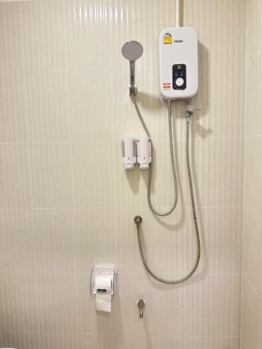 a bathroom with a shower with a soap dispenser at Cozy & Affordable apartment in Chiang Mai in Chiang Mai