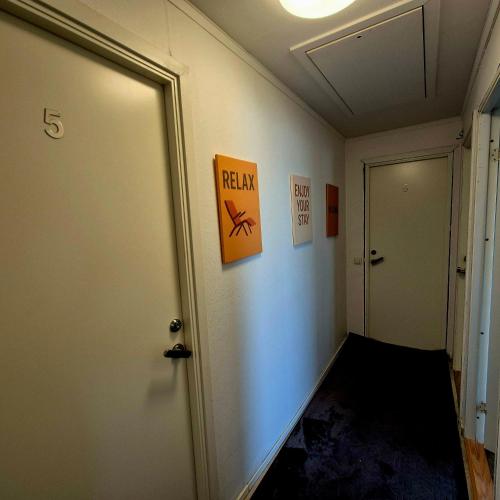 an office hallway with a door and a sign on the wall at SO Easy Stay, Malmö in Malmö