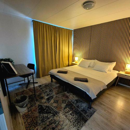 a bedroom with a large bed and a piano at SO Easy Stay, Malmö in Malmö