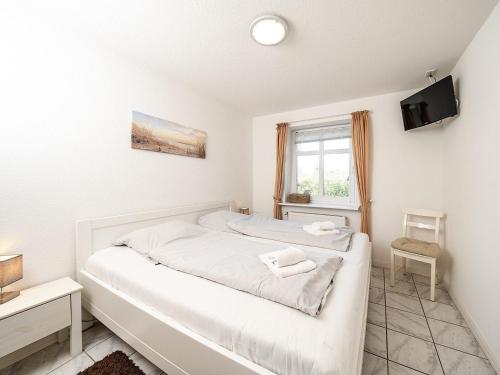 Ένα ή περισσότερα κρεβάτια σε δωμάτιο στο Moderne Doppelhaushälfte nahe Strand und Deich in Dagebüll