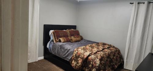 a bedroom with a bed with two pillows on it at Spacious 3-Bedroom House in Atl in Atlanta