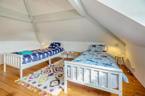 two beds and a rug in a room at 3 Bed in Harlech oc-g33093 in Harlech