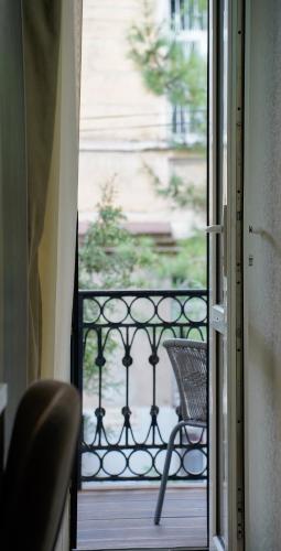 an open door to a balcony with a chair at Hotel Griboedov in Tbilisi City