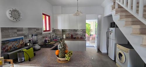 a kitchen with a sink and a counter top at Barefoot Beach House in Larnaca