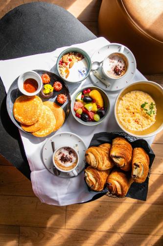 a plate of food with different types of breakfast foods at Hotel OFF Paris Seine in Paris