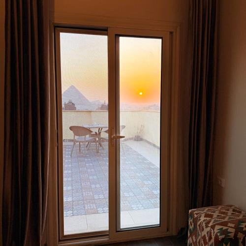 a sliding glass door with a view of a patio at Five Pyramids Peaks View in Cairo
