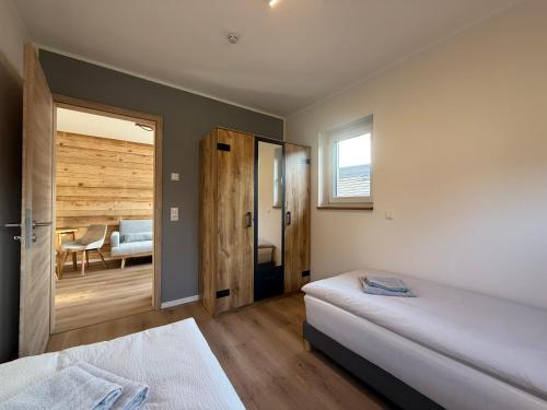 a bedroom with two beds and a sliding glass door at Kamp 27 in Bebertal Zwei