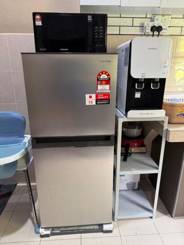 a microwave oven sitting on top of a machine at Laman Bangau Temerloh in Temerloh