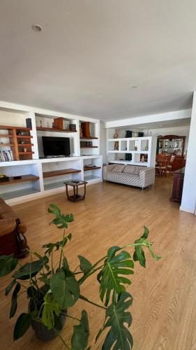a living room with a plant in the middle of it at Oceans House Villa in Carcavelos