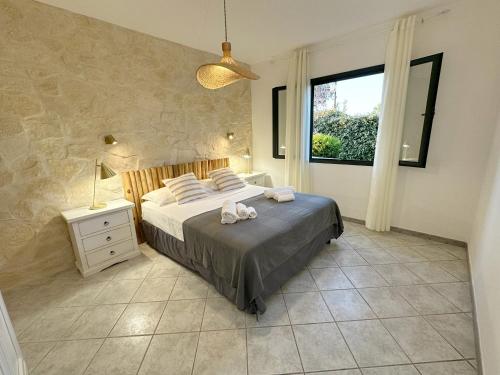 a bedroom with a bed and a window at Exclusive Getaways by SardegnaSummer in San Teodoro