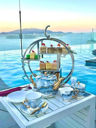 a table with a tea set on top of the water at Coastal Charm Panorama Bayview in Nha Trang