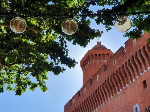 a tall red brick building with a clock tower at ibis budget Perpignan Centre Rénové en 2025 in Perpignan