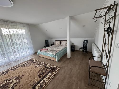 a bedroom with a bed and a large window at Садиба Ангеліка in Csetfalvát
