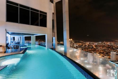 a swimming pool on the roof of a building at night at Coastal Charm Panorama Bayview in Nha Trang