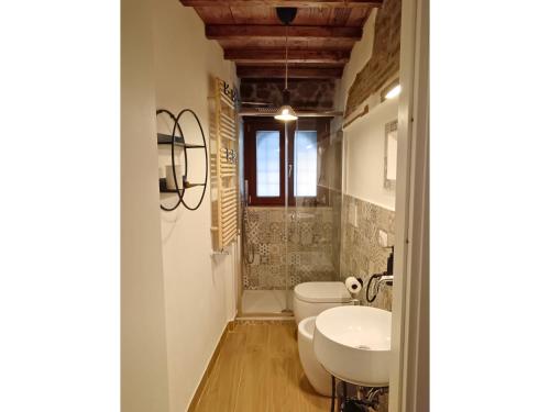 a bathroom with a toilet and a sink at La Casina di Rosina in Sacrofano